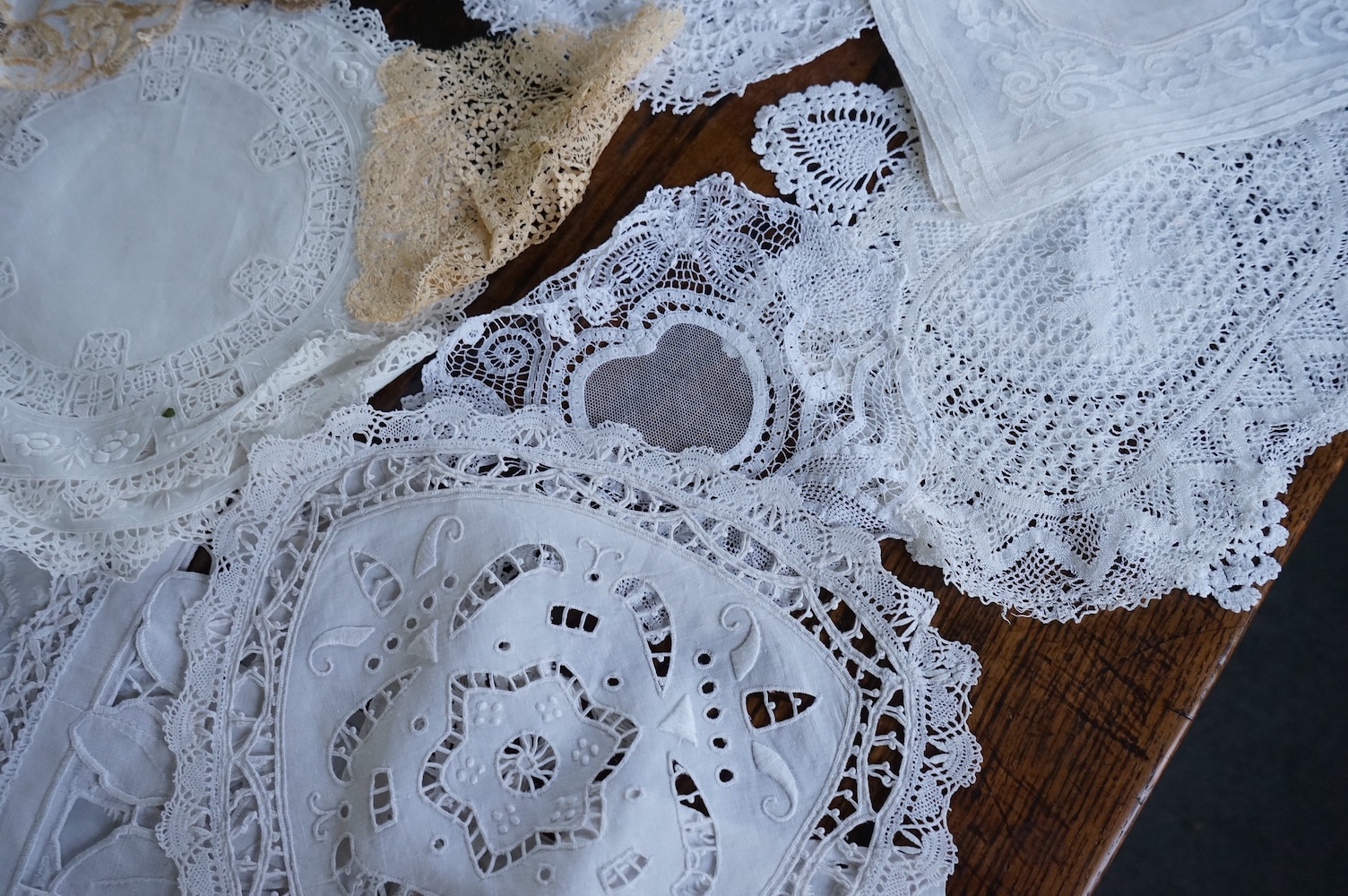 A 19th century large linen cut work collar, together with various sets of circular cut work mats, a tasselled pelmet and a collection of bobbin lace and tatting worked mats etc., Condition - mostly good